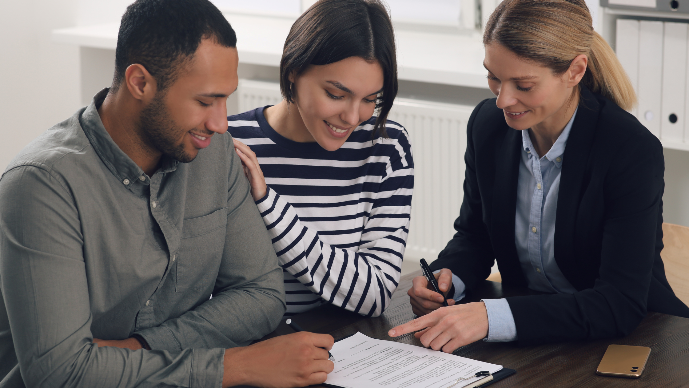 Young couple signing a contract